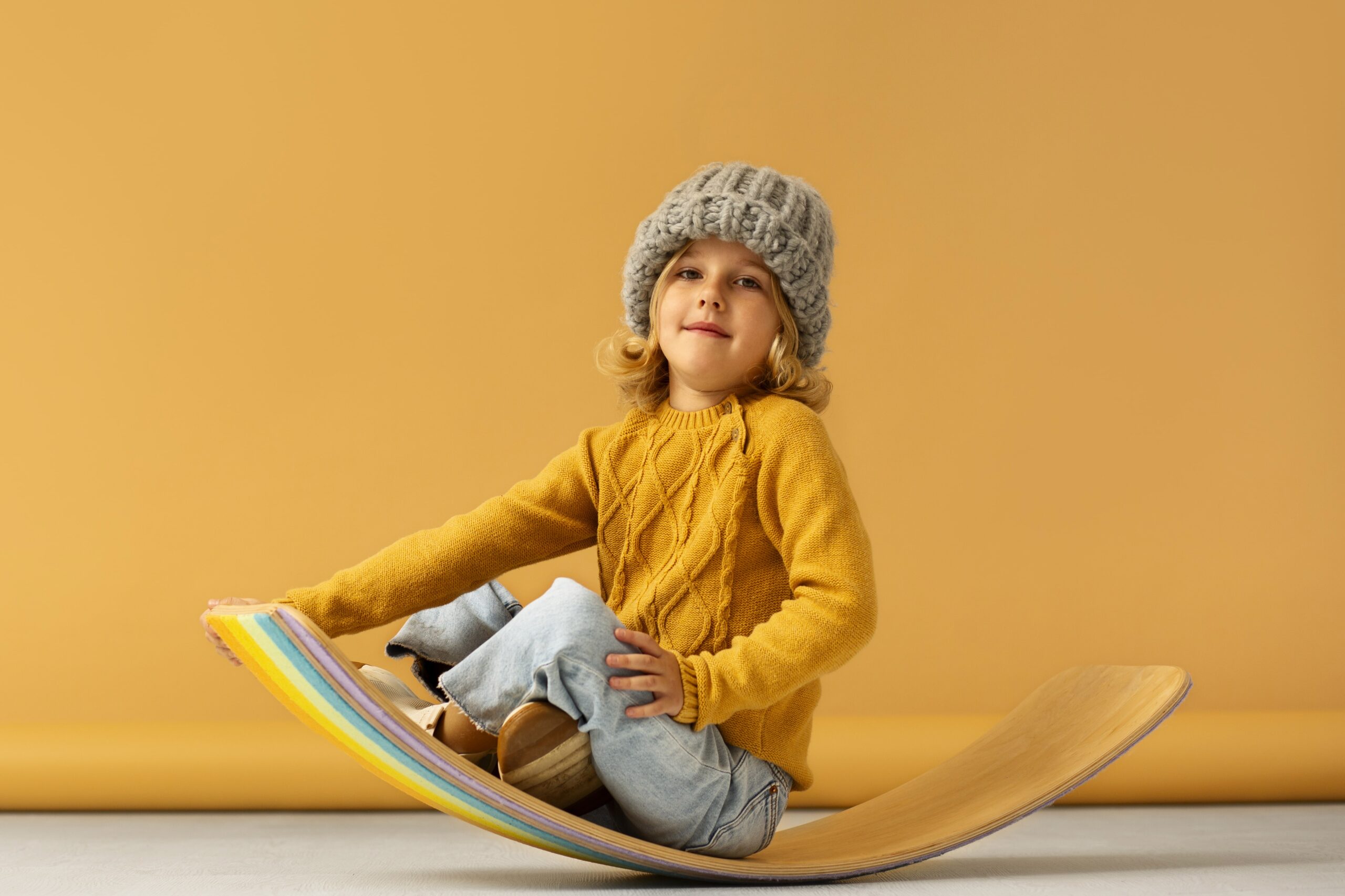 full-shot-smiley-kid-sitting-studio-min